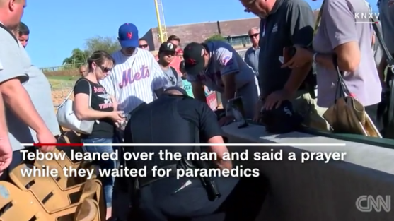 tim-tebow-prays-over-man